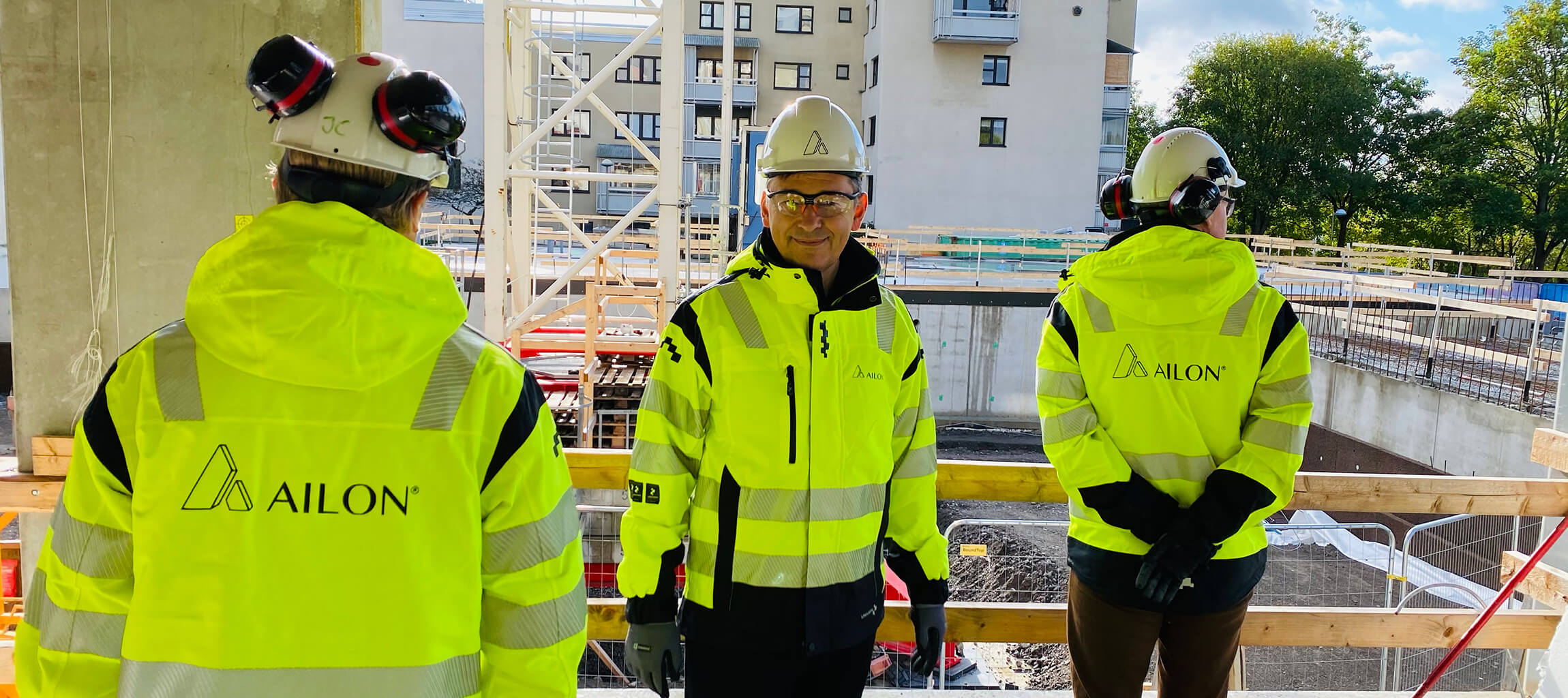 Ailon team in high-visibility jackets on a construction site